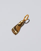 View from the side of the Carl Auböck Brass Foot Keyring on light color background.