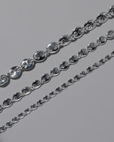 Closeup details of the CRZM Sterling Silver Bedrock Mini Necklace, Sterling Silver Bedrock Medium Necklace, and Sterling Silver Bedrock Necklace on light color background.
