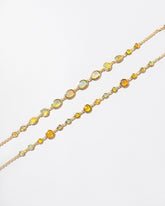 Ops Bracelet and Saturn Bracelet on light color background.