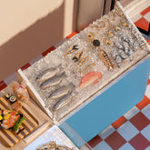product_details::Styled image featuring the Pavé and Solid Gold Fish Charms, Shrimp Cocktail Charm, Caviar Charm, Lobster Tail Charm, Fish Charm, Clam on Half Shell Charm and Stone Crab Claw Charm.