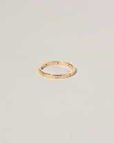 Gold 2mm Square Wire Band with Six Stone White Diamond 1.6mm added on light color background.