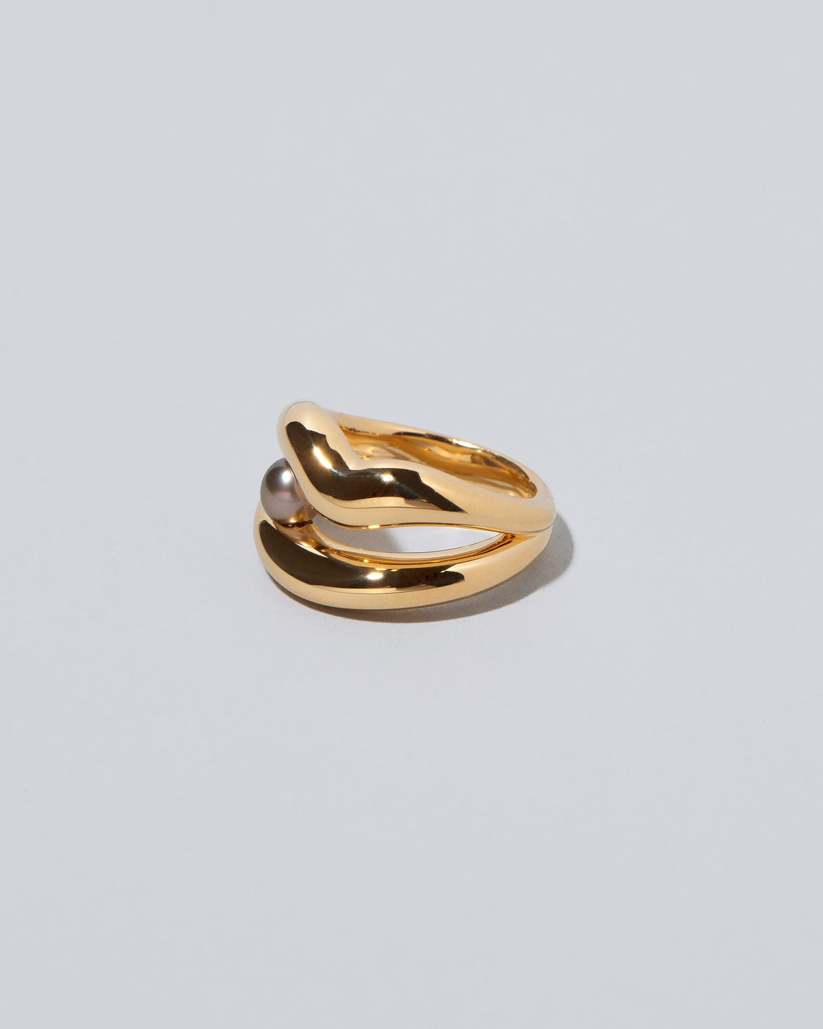 View from the side of the Ocean of Unity Ring on light color background.