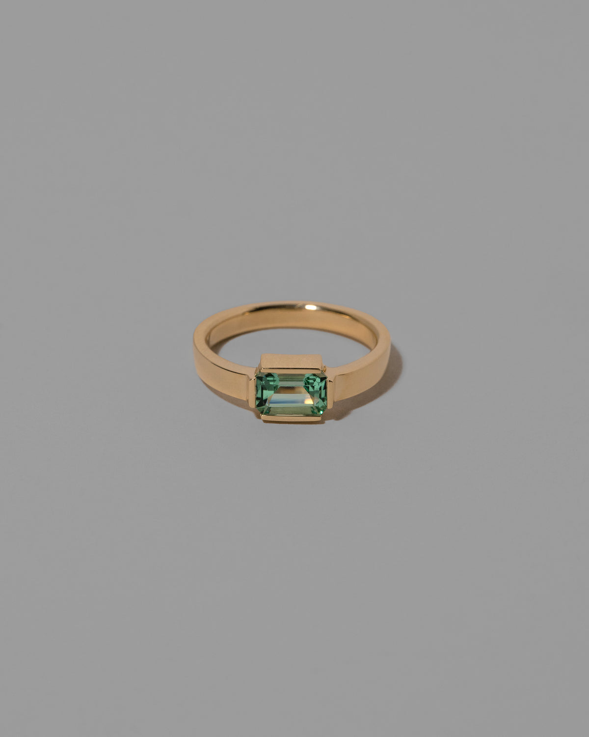 Emerald Fold Ring on light color background.