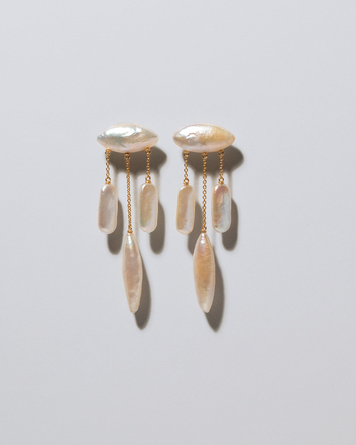 Egret Pearl Earrings on light color background.