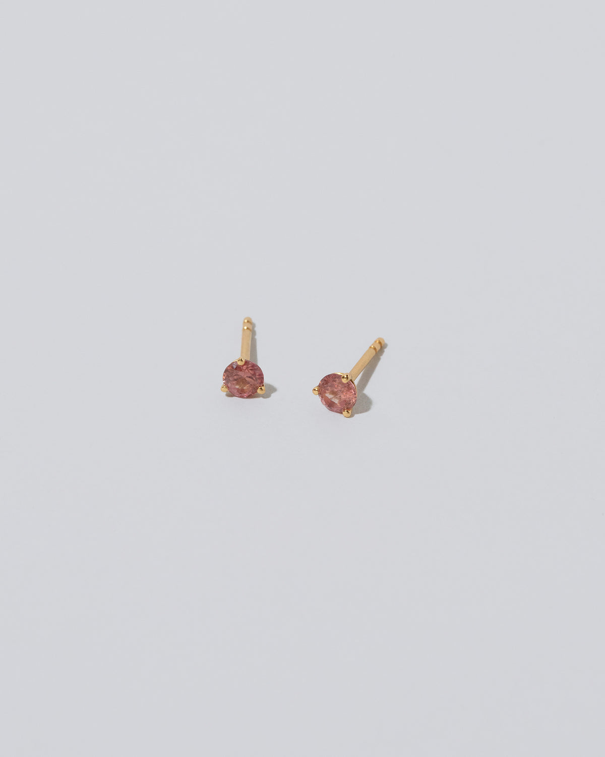 Martini Stud - Coral Sapphire on light color background.