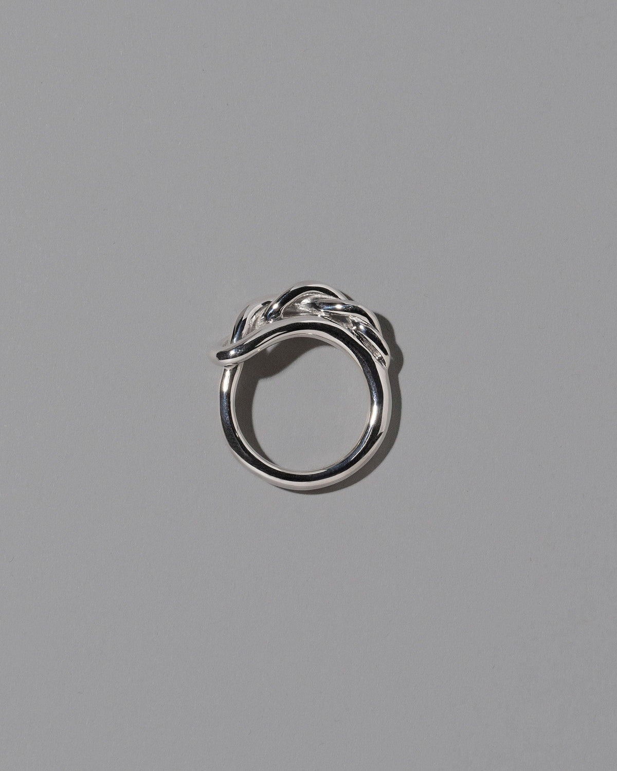 View from the side of the CRZM Sterling Silver Ophiolite Ring on light color background.
