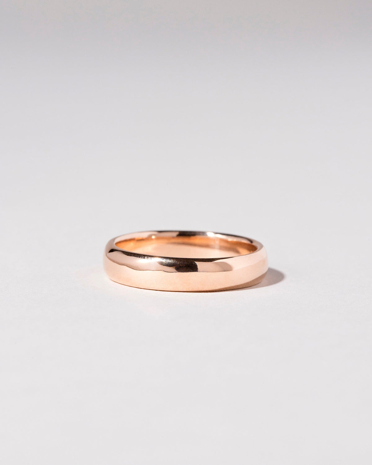 Rose Gold 5mm Half Round Band on light color background.