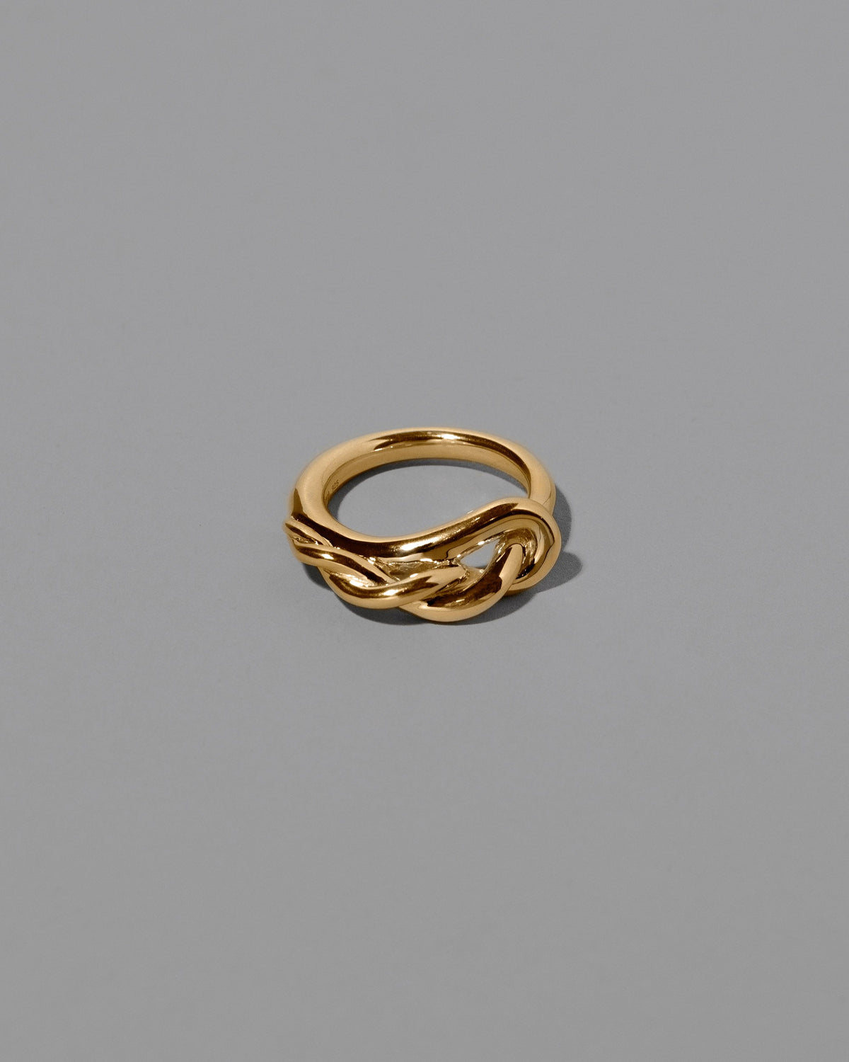 CRZM Gold Ophiolite Ring on light color background.