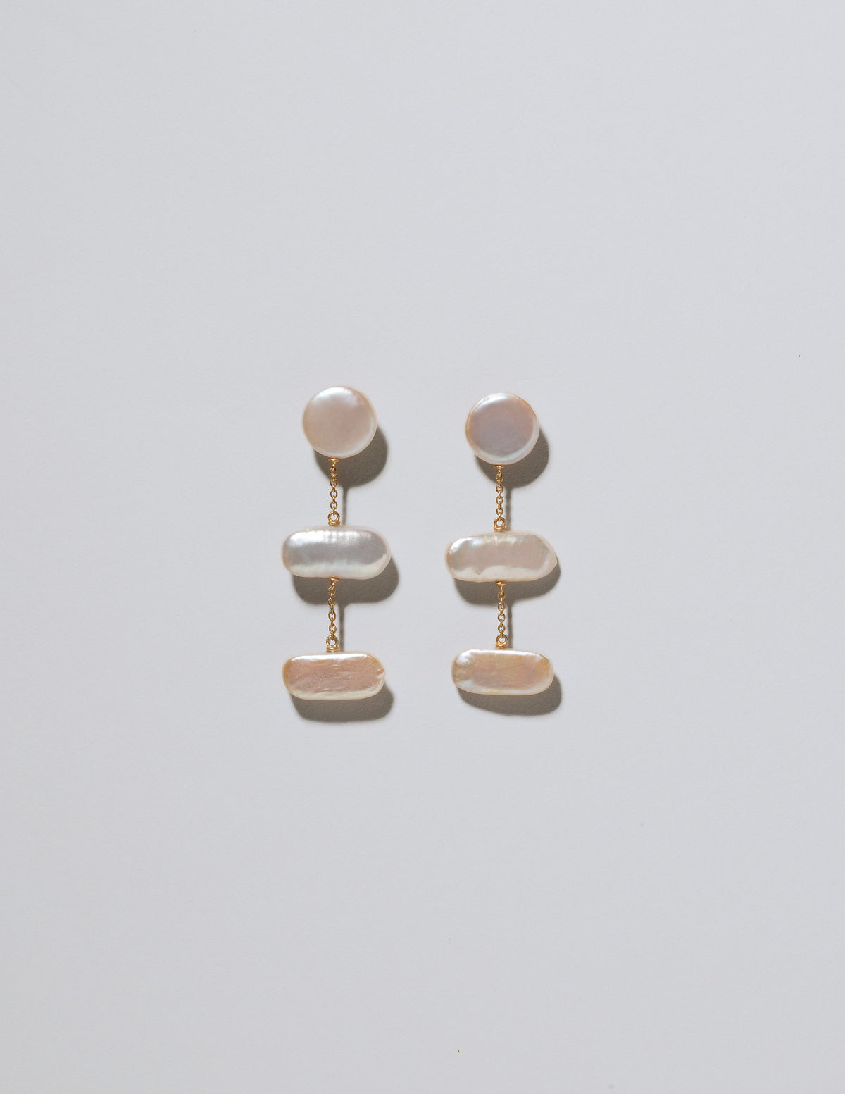 Kittiwake Earrings on light color background.