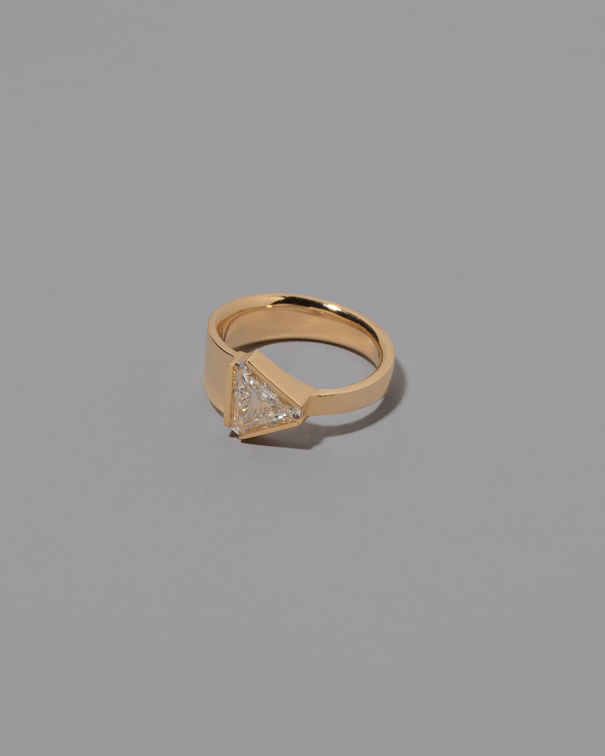 View from the side of the Tuck Ring on grey color background.