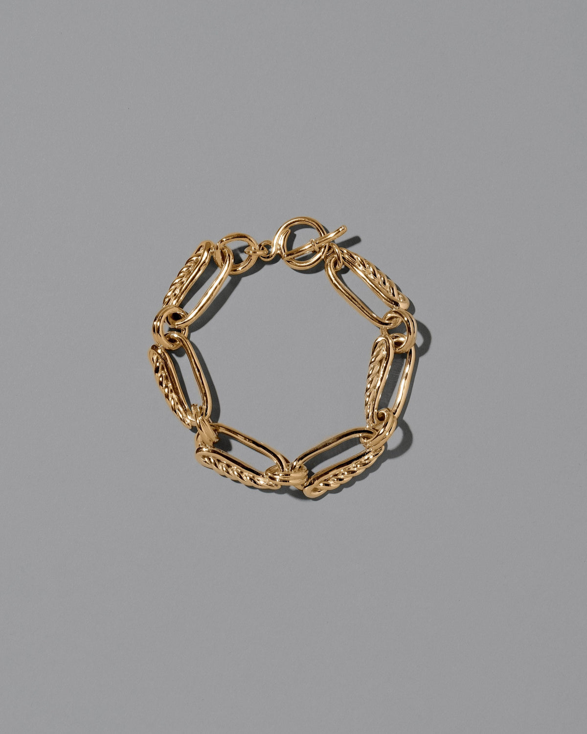 CRZM Gold Ophiolite Bracelet on light color background.