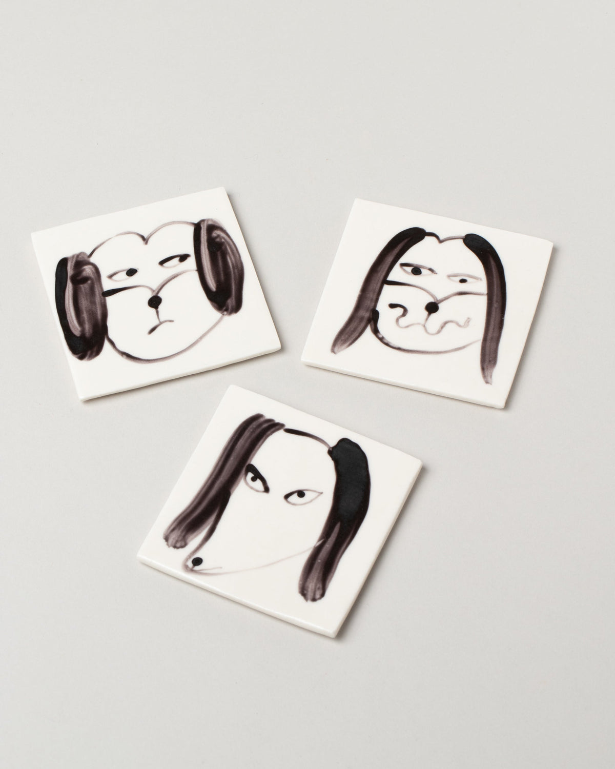 Eleonor Boström Dog Face Coasters on light color background.