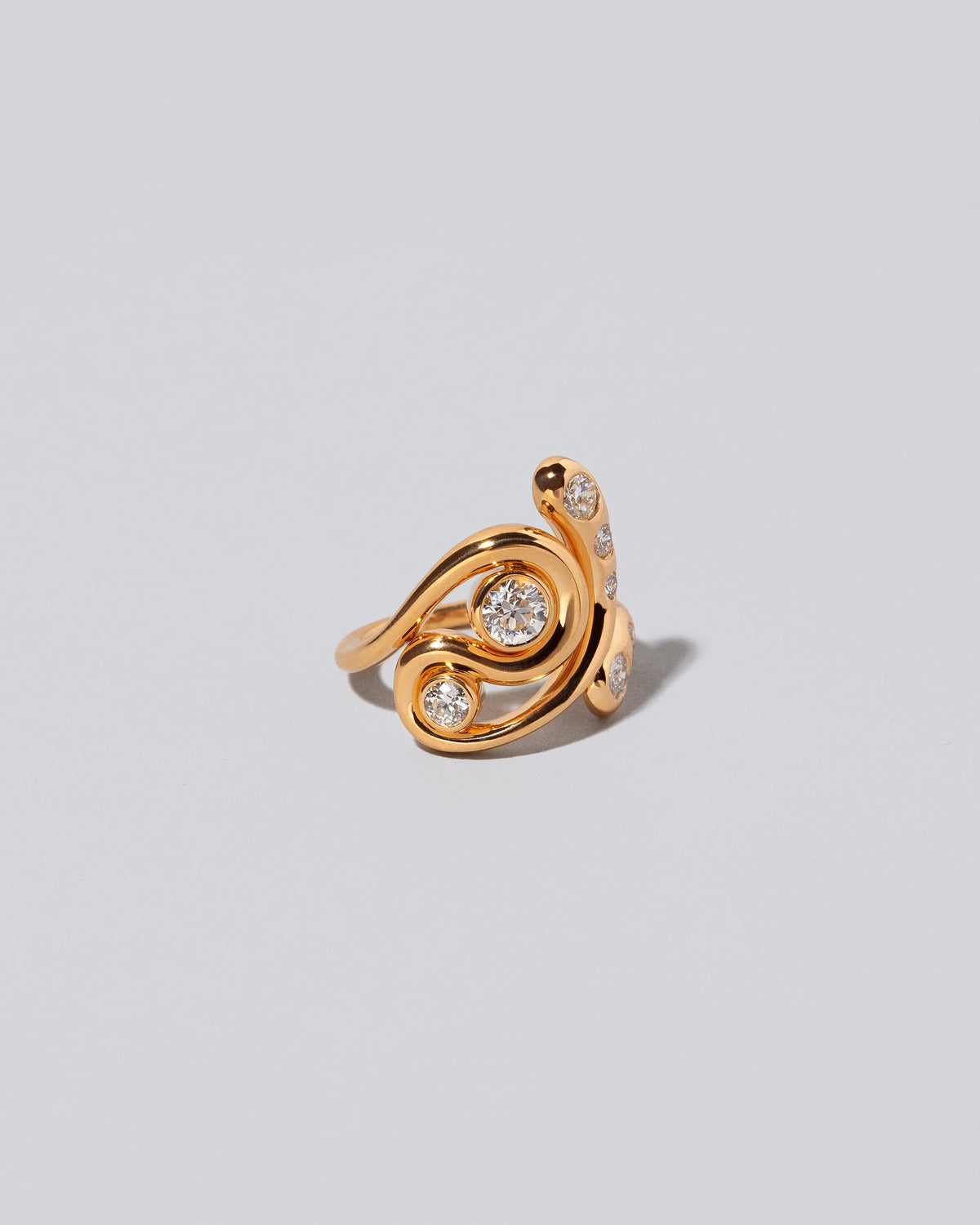View from the side of the Twist It Ring on light color background.