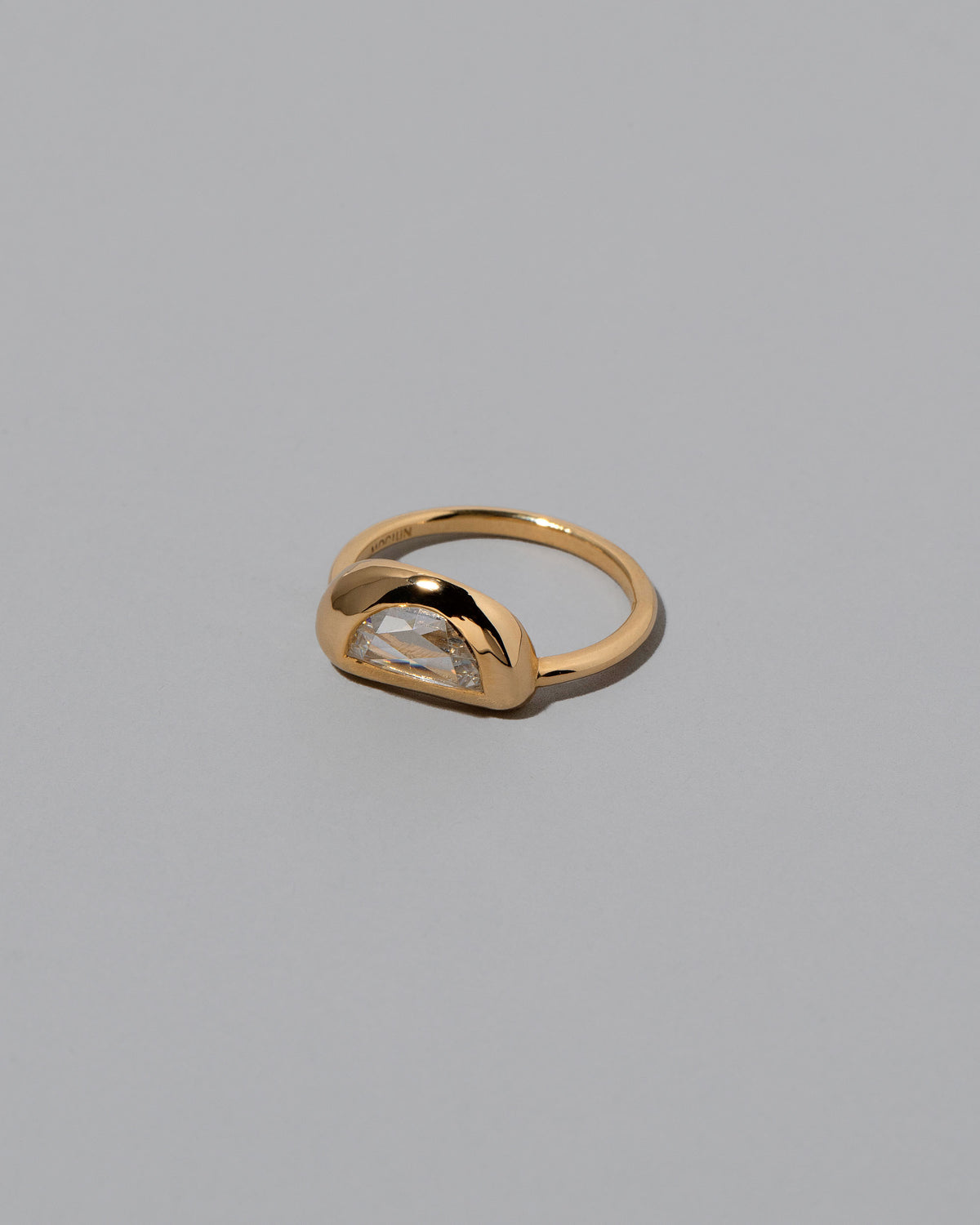 View from the side of the Lined Up Ring on light color background.