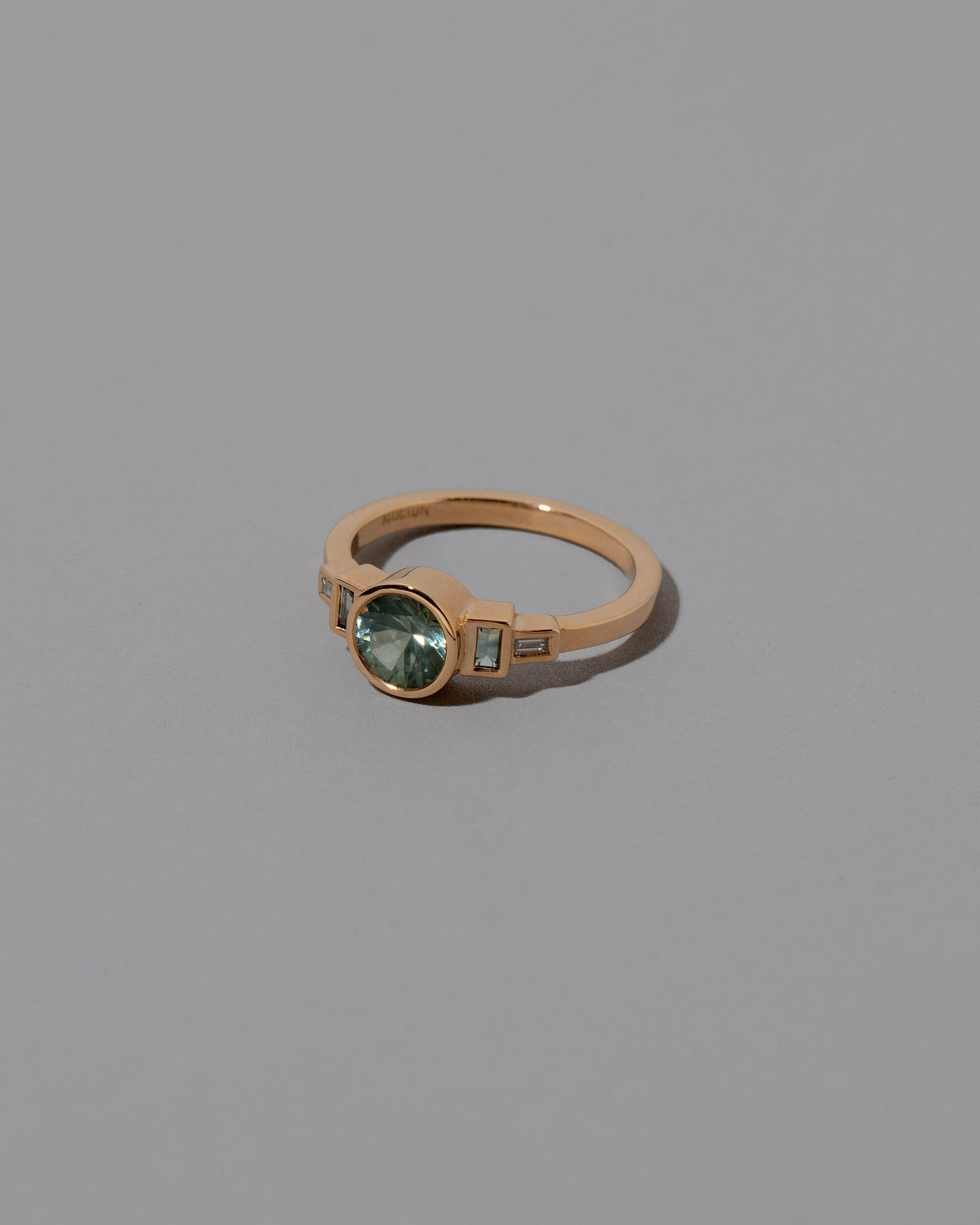 View from the side of the Richness Ring on grey color background.