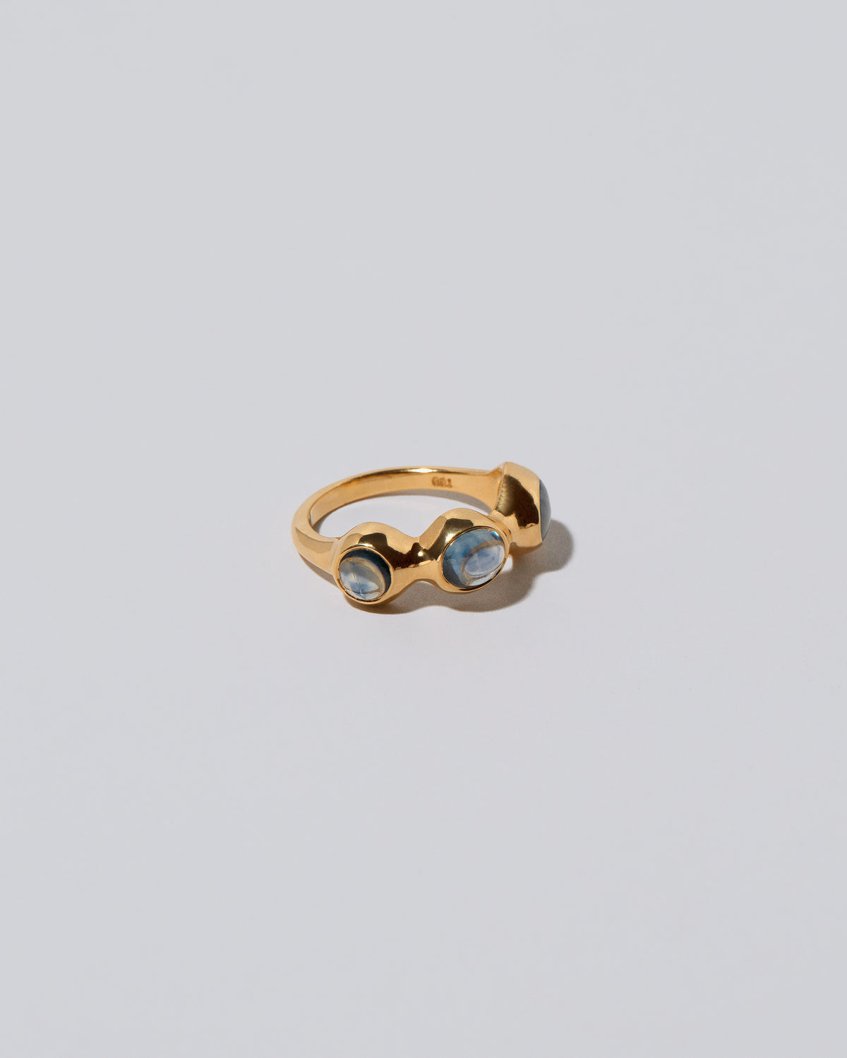 View from the side of the Sword Swallower Ring on light color background.