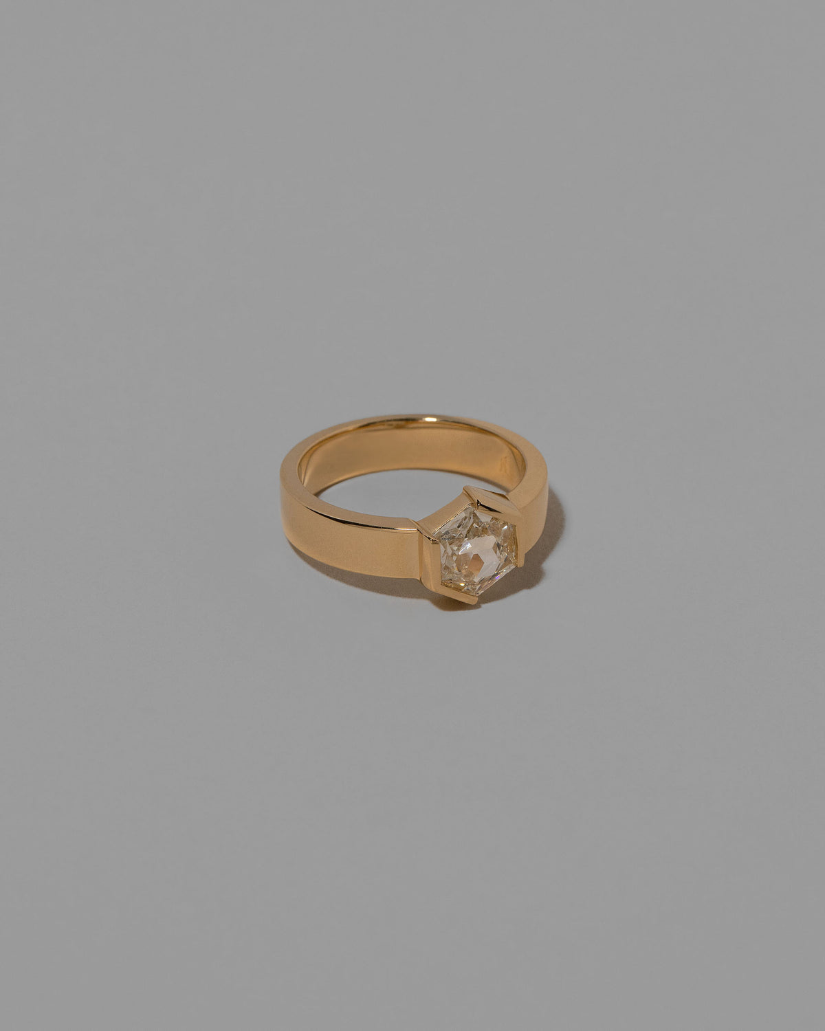 View from the side of the Devotion Ring on light color background.