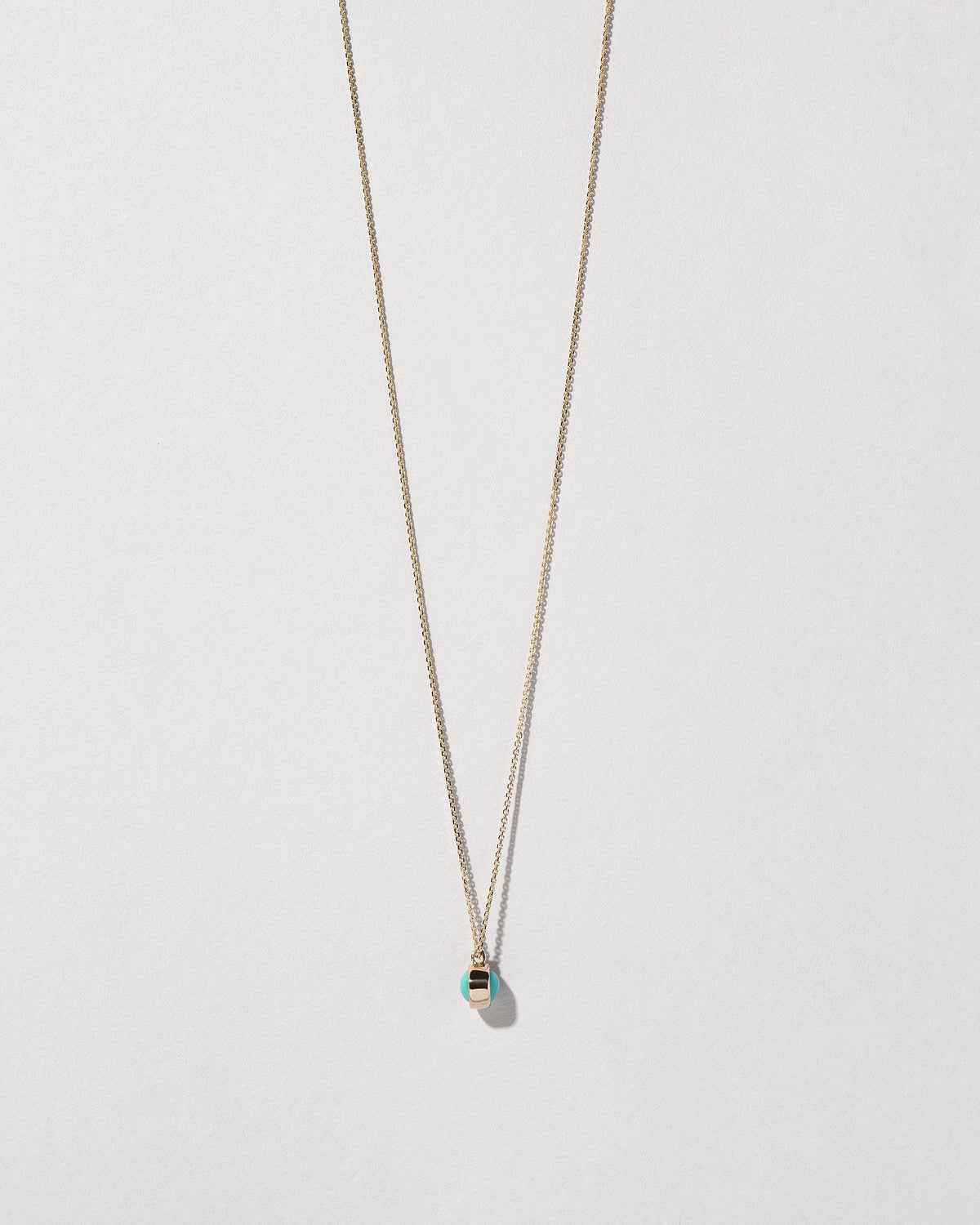 Turquoise Birthstone Necklace on light color background.