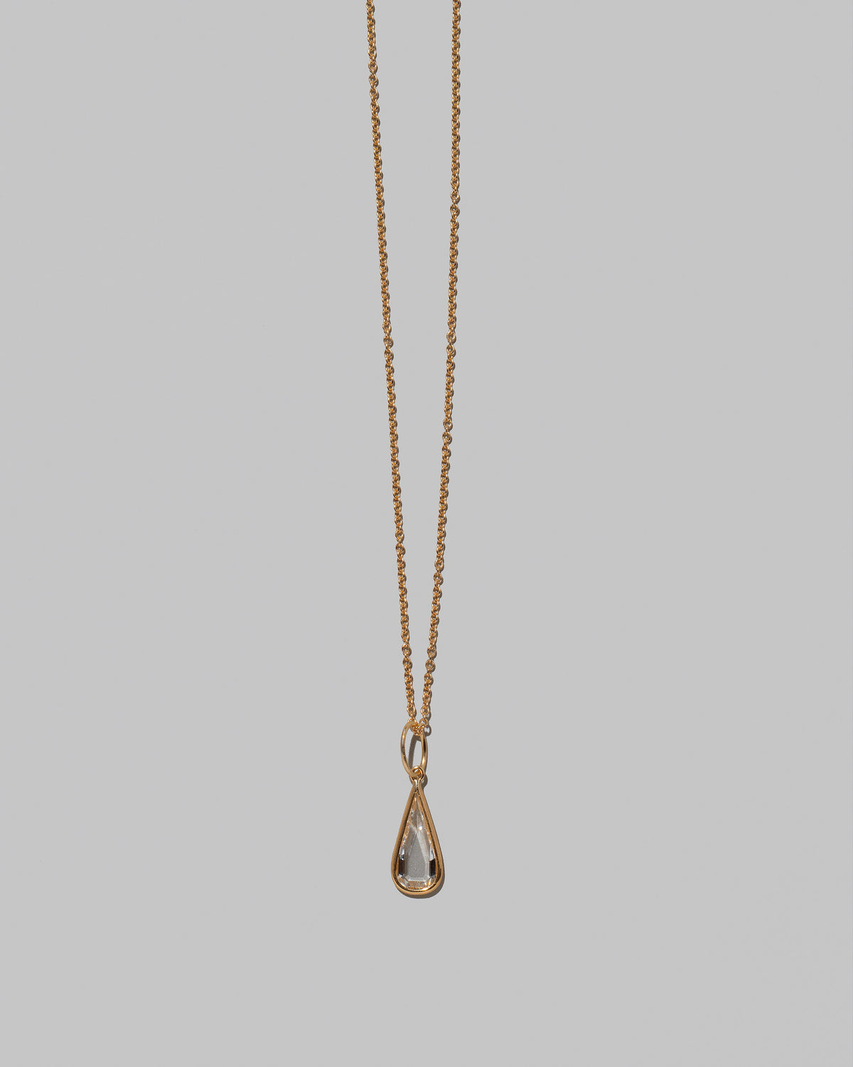 Closeup details of the State Shifter Diamond Pendant paired with chain on light color background.