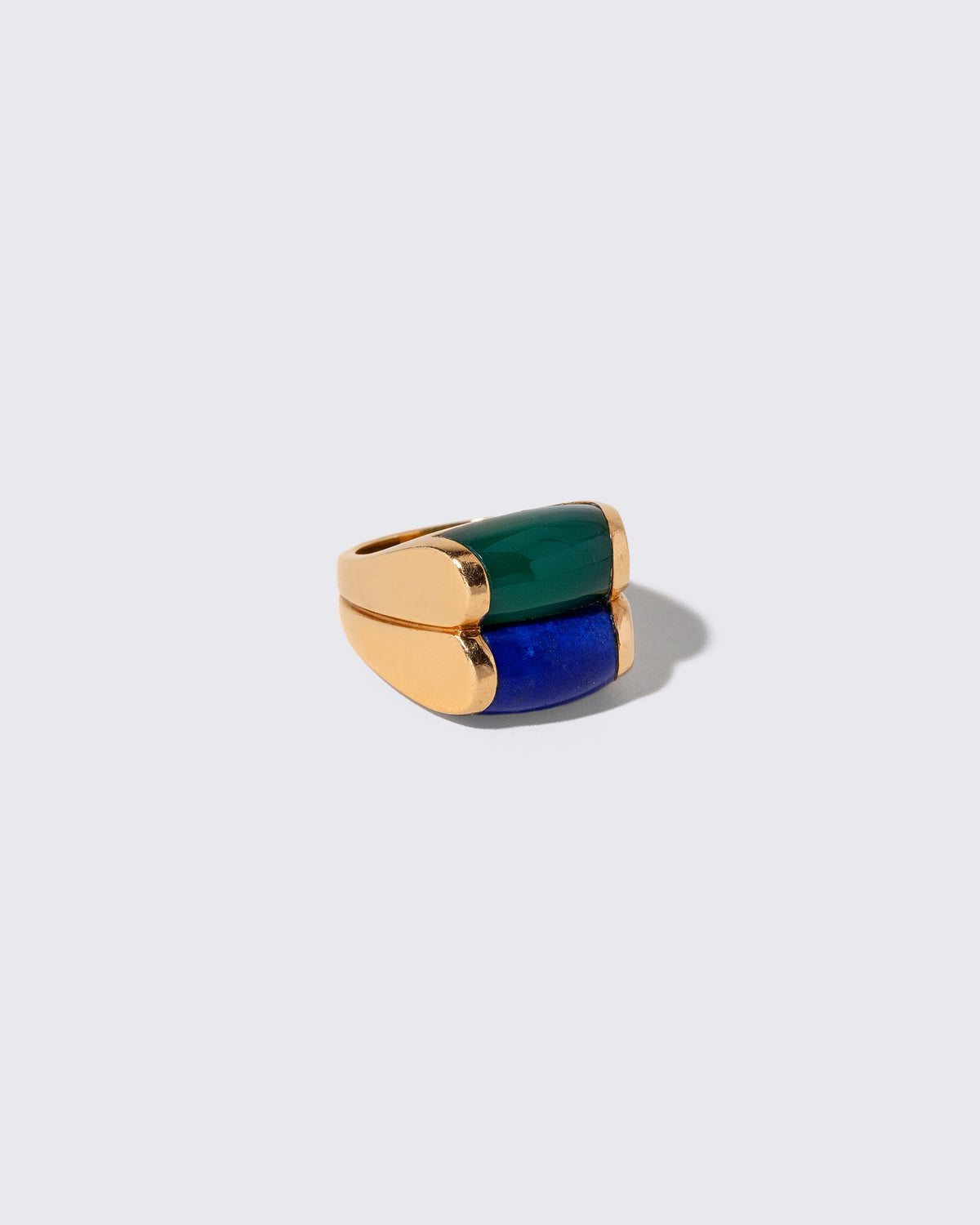 View from the side of the Vintage Bvlgari Doppio Tronchetto Lapis & Chalcedony Ring on light color background.