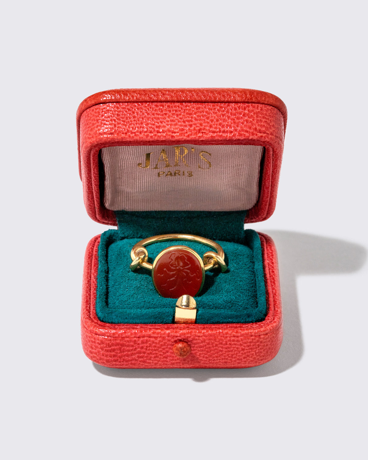 Inside view of the Vintage JAR Carnelian Ring With Box on light color background.