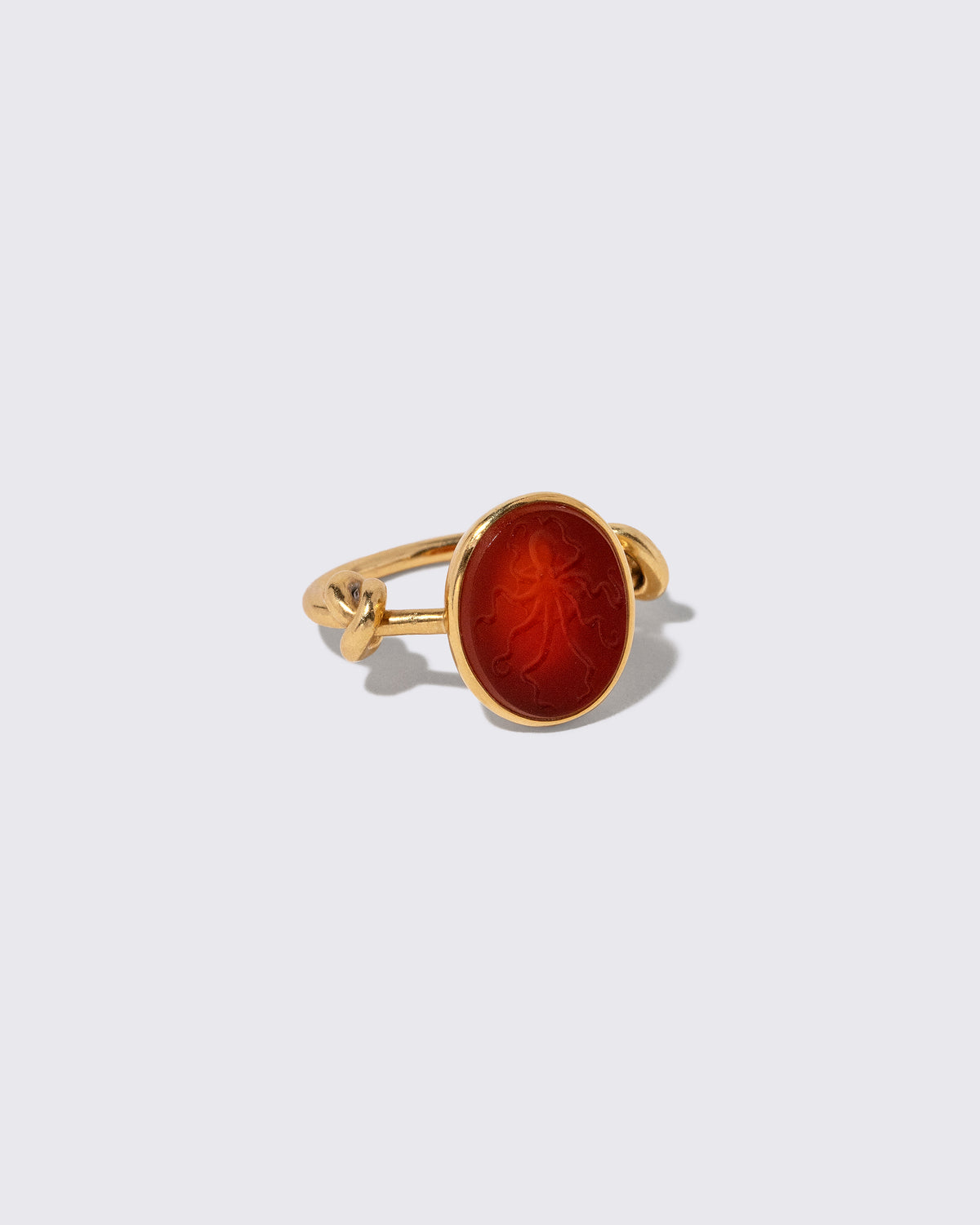 View from the side of the Vintage JAR Carnelian Ring on light color background.