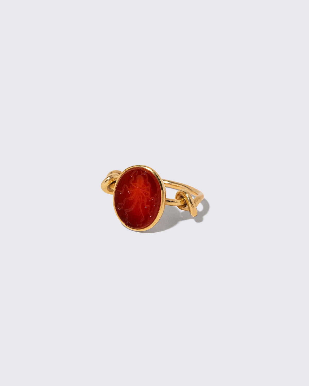 View from the side of the Vintage JAR Carnelian Ring on light color background.