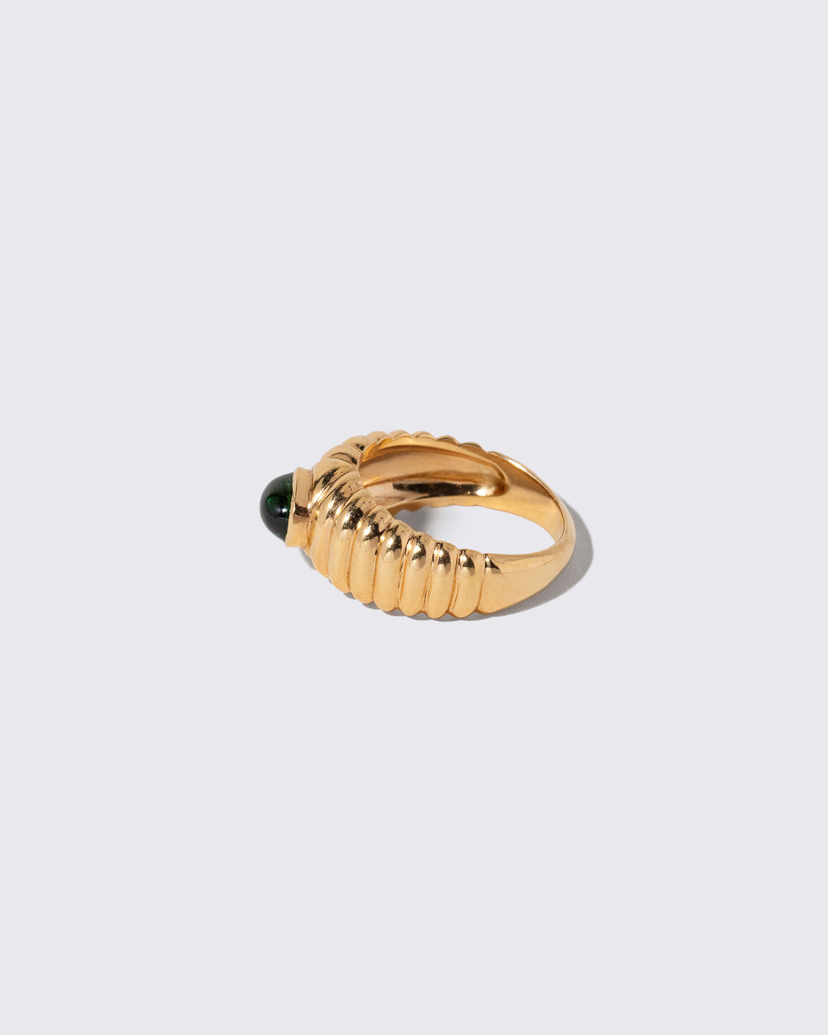 Detail view of the Vintage Ribbed Peridot Ring on light color background.