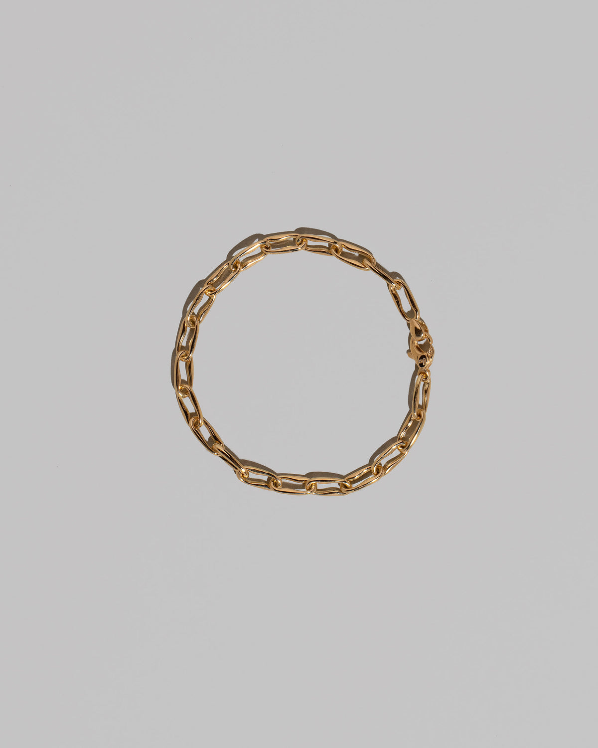 Wavy Link Chain Bracelet on light color background.