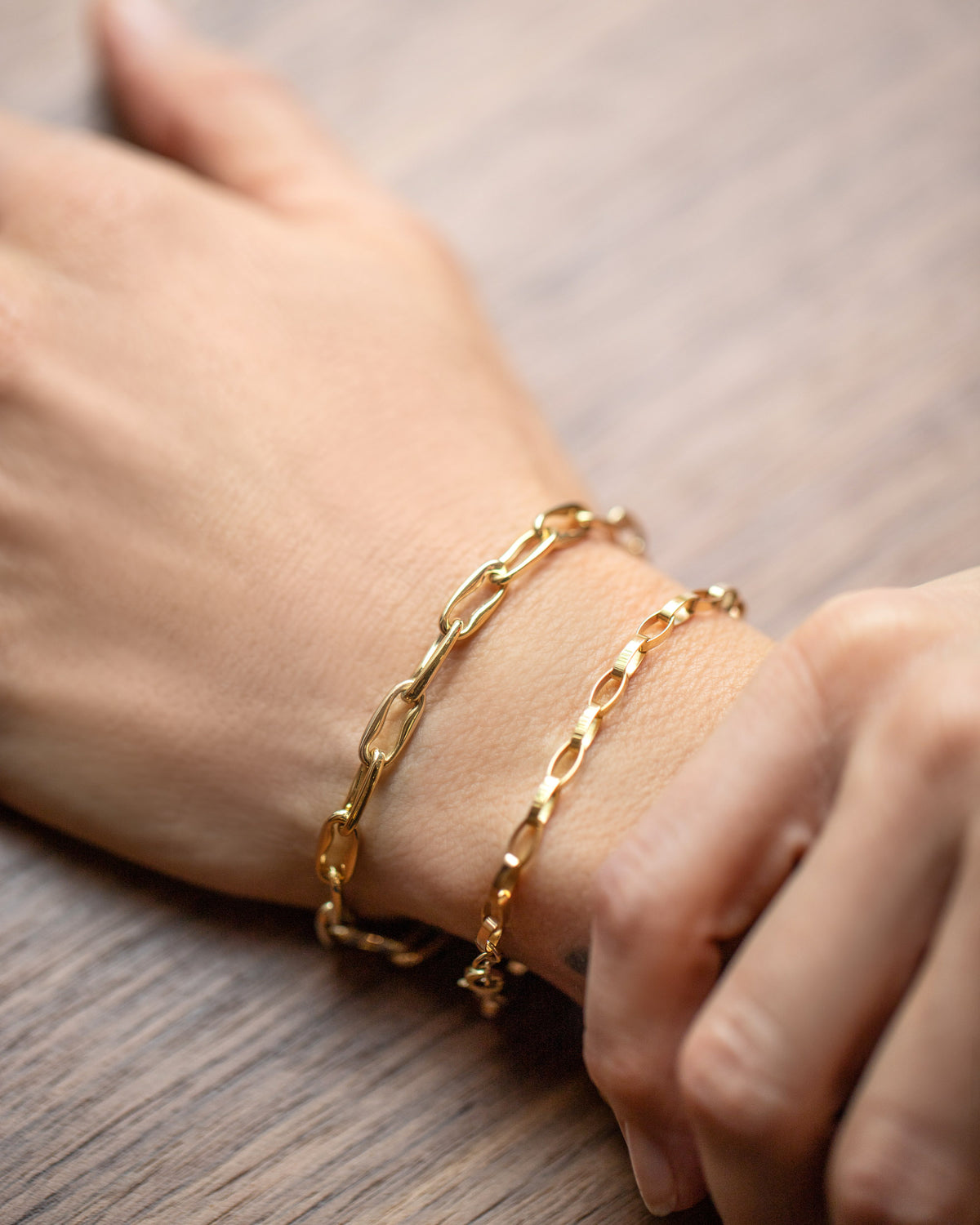 Wavy Link Chain Bracelet and Flat Oval Link Chain Bracelet on model.