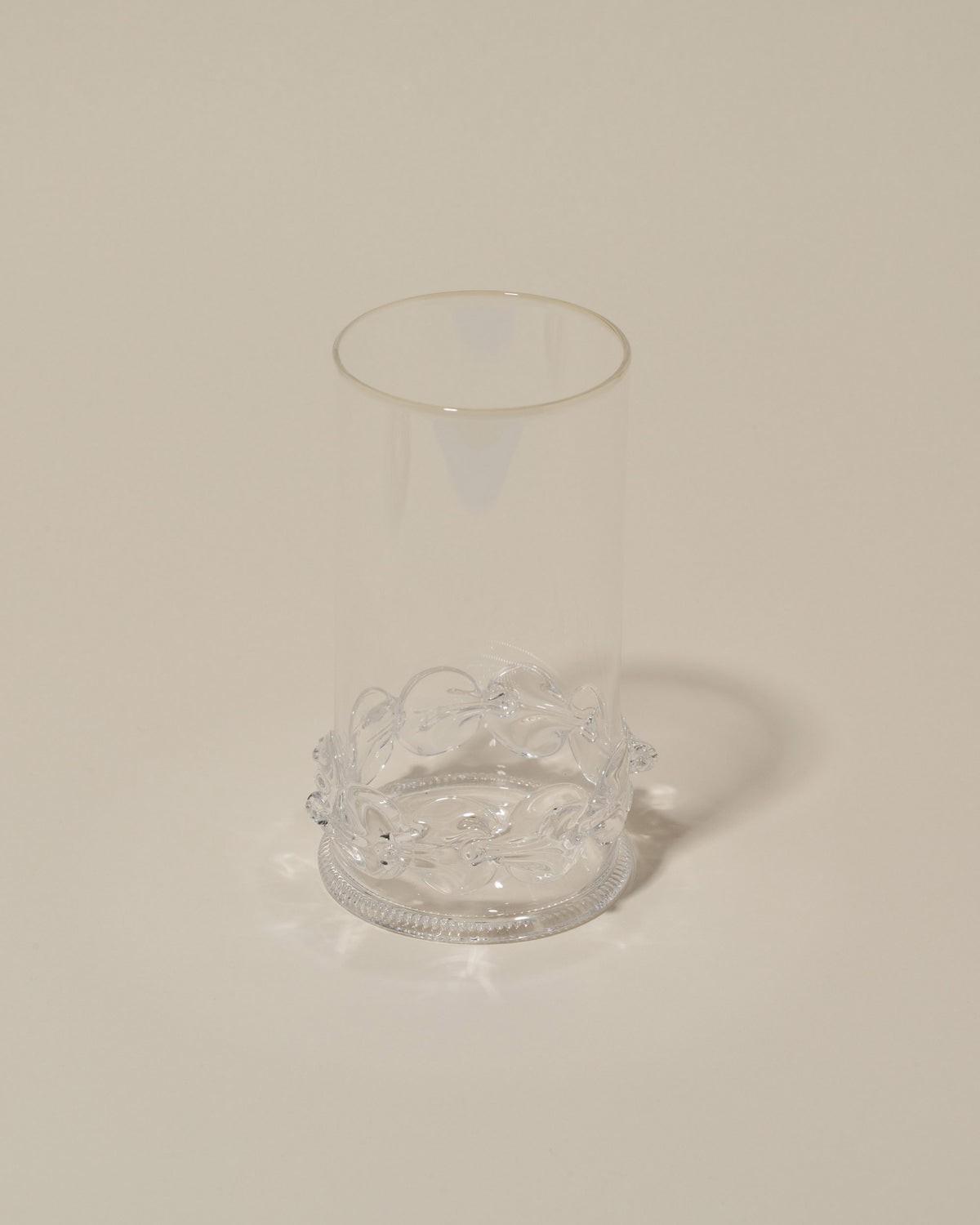 Closeup details of the Bollenglass Design Clear Dot Highball Glass on light color background.
