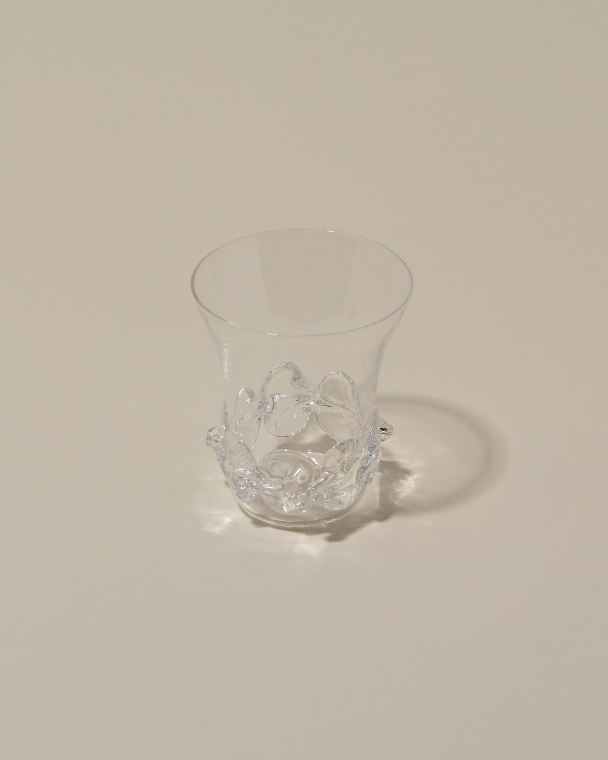 Closeup details of the Bollenglass Design Clear Liquor Glass on light color background.
