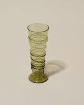 Closeup details of the Bollenglass Design Green Petite Spiral Tumbler on light color background.