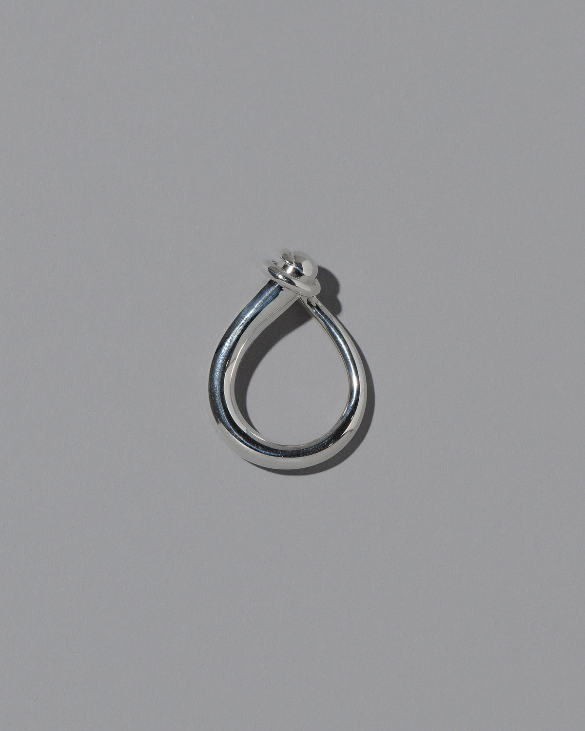 View from the side of the CRZM Sterling Silver Boulder Ring on light color background.