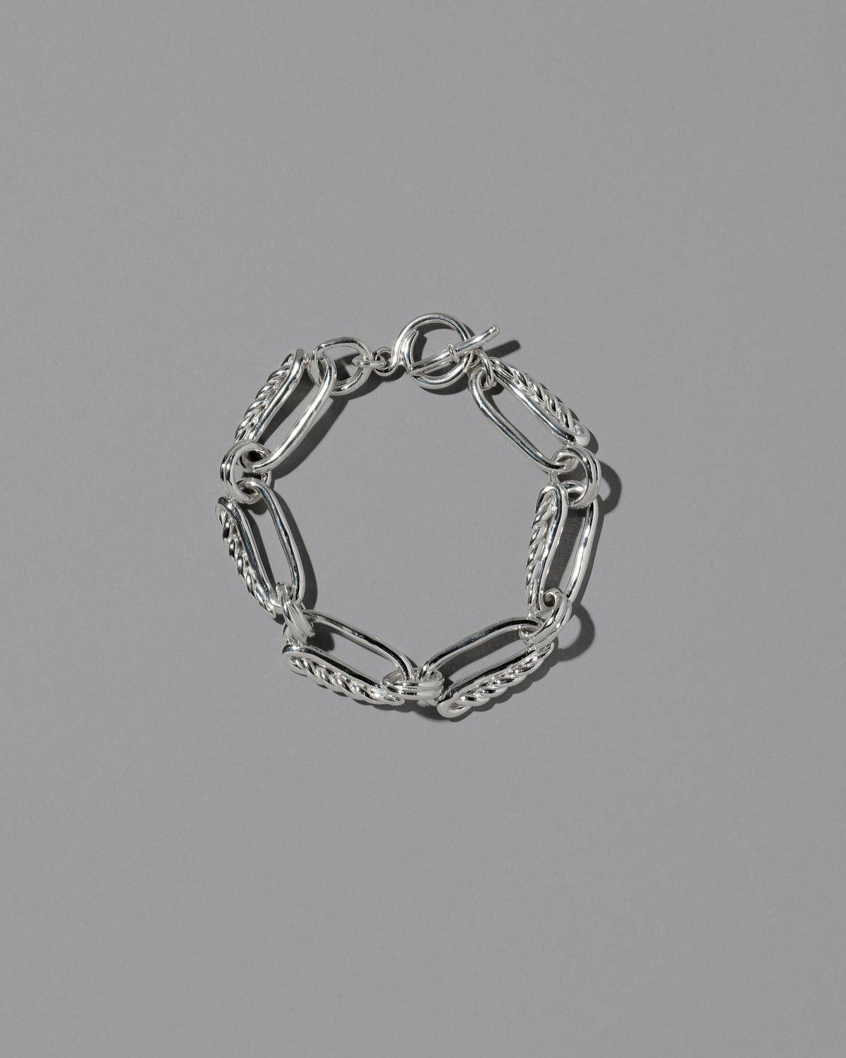 CRZM Sterling Silver Ophiolite Bracelet on light color background.