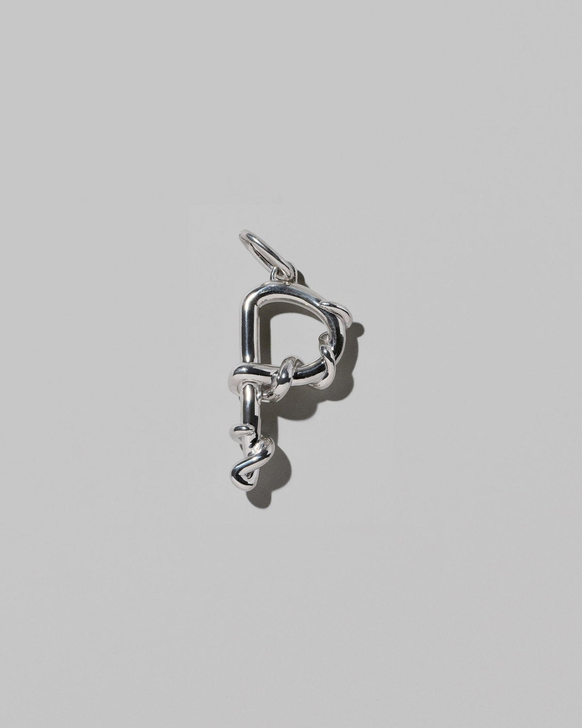 CRZM Sterling Silver Letter P Bag Charm on light color background.