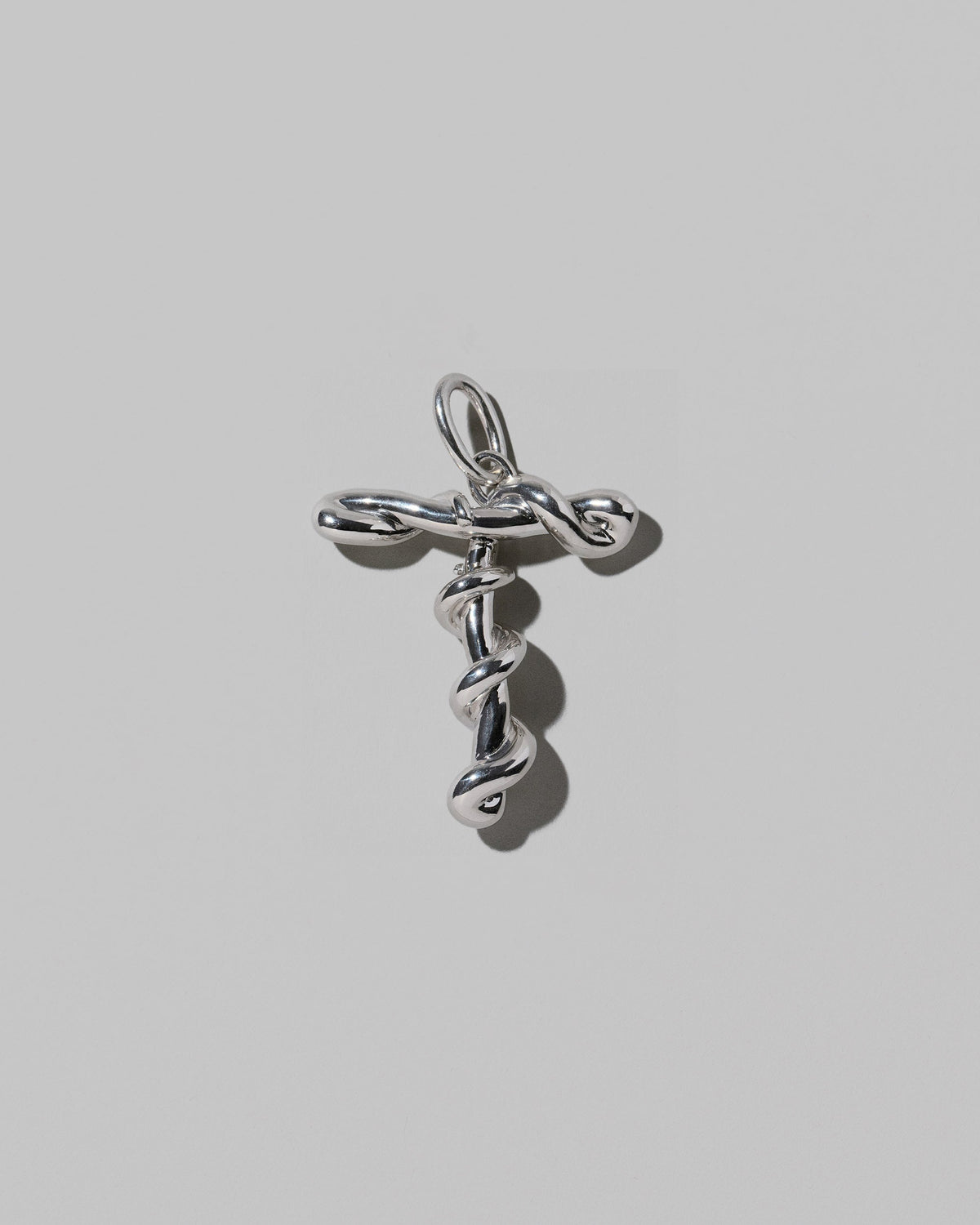 CRZM Sterling Silver Letter T Bag Charm on light color background.