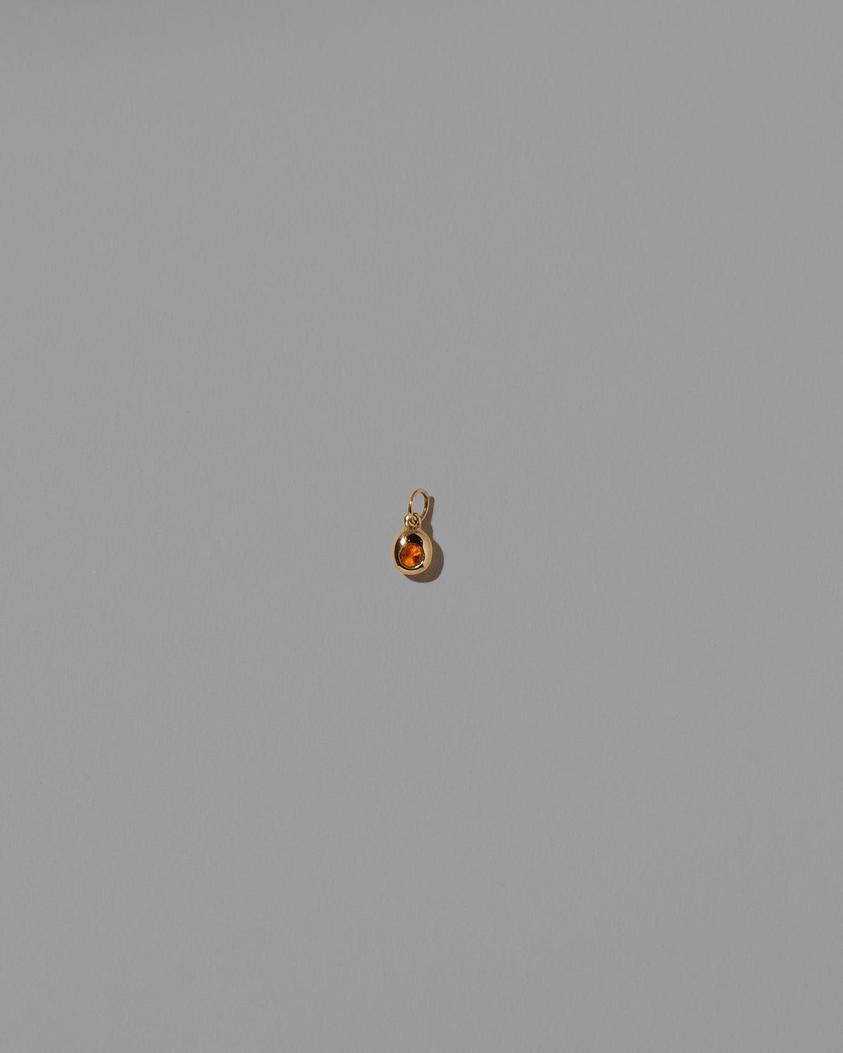 Citrine Birthstone Level Charm on light color background.