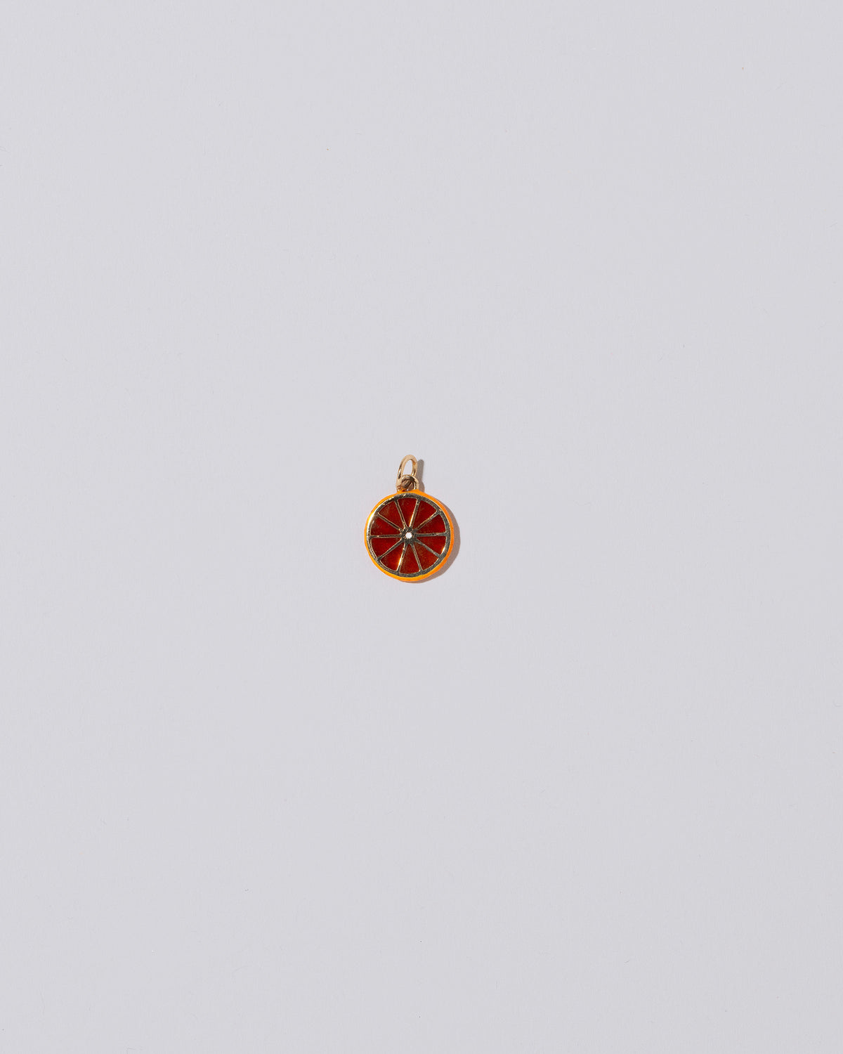 Large Tangerine Slice Charm on light color background.