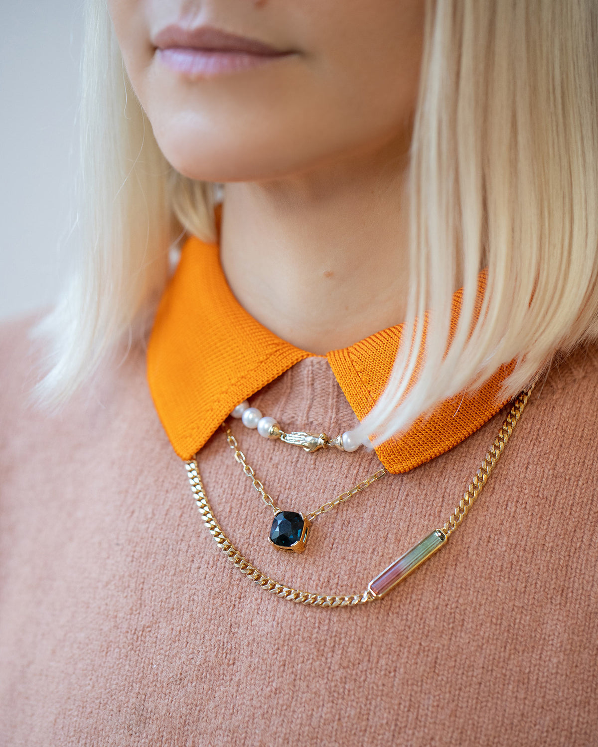 Gold White Union Necklace, Awareness Necklace and Deliverance Necklace on model.