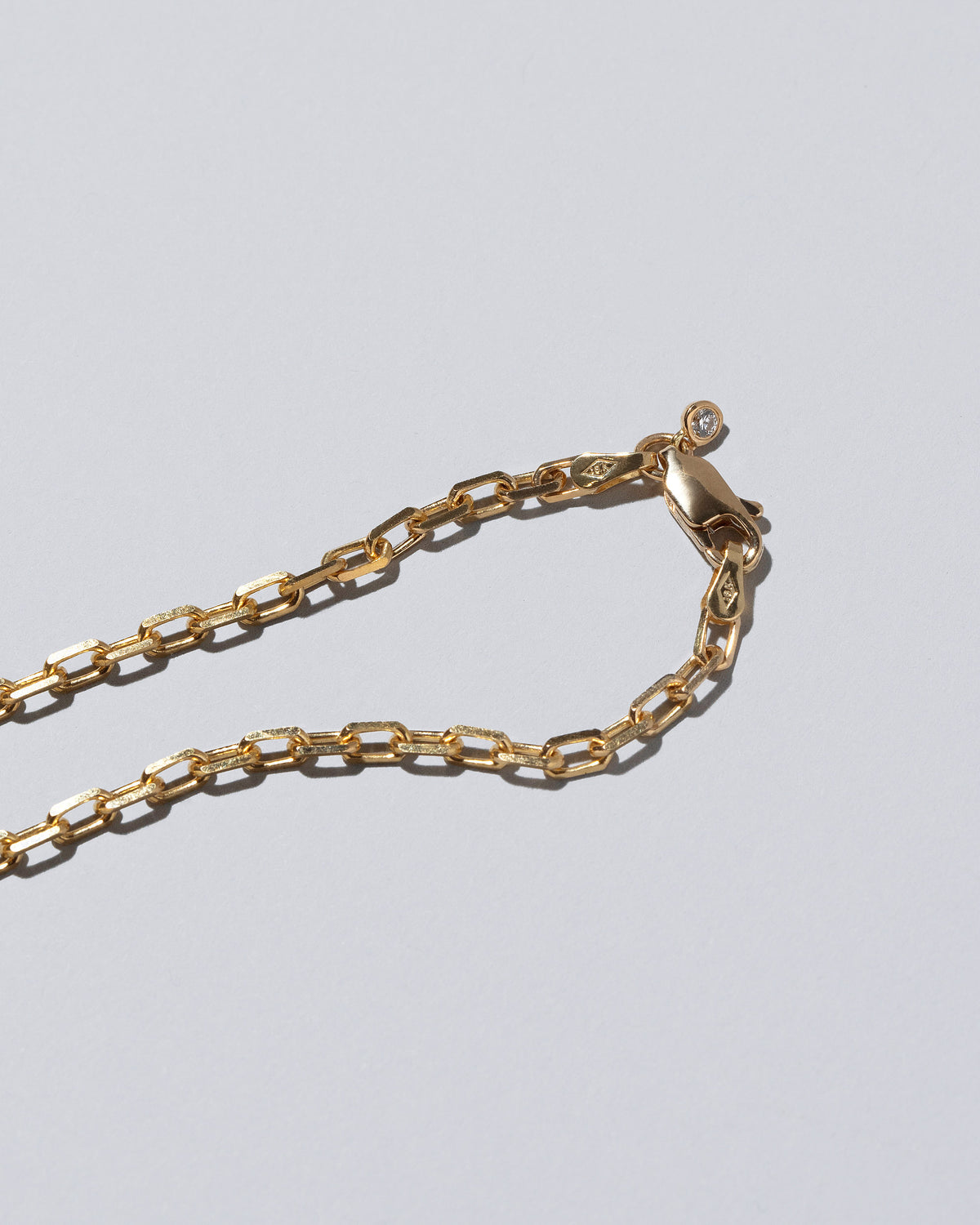 View from the back of the Awareness Necklace on light color background.