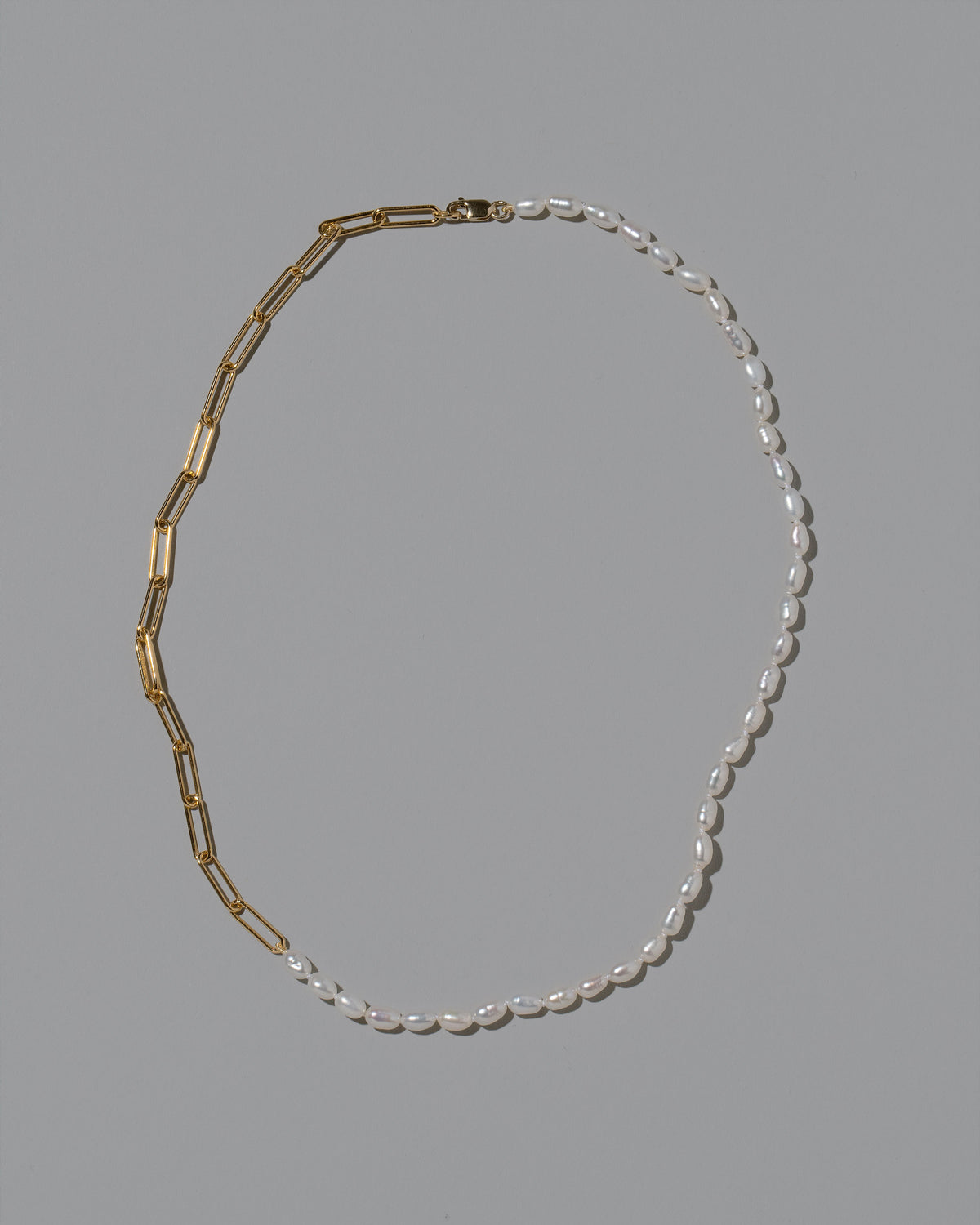 Rice Pearl Long Oval Necklace on light color background.