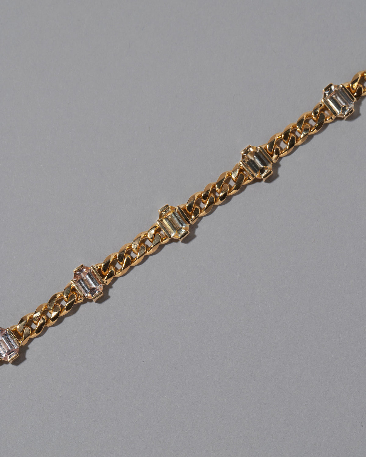 Closeup details of the Envelop Bracelet on grey color background.