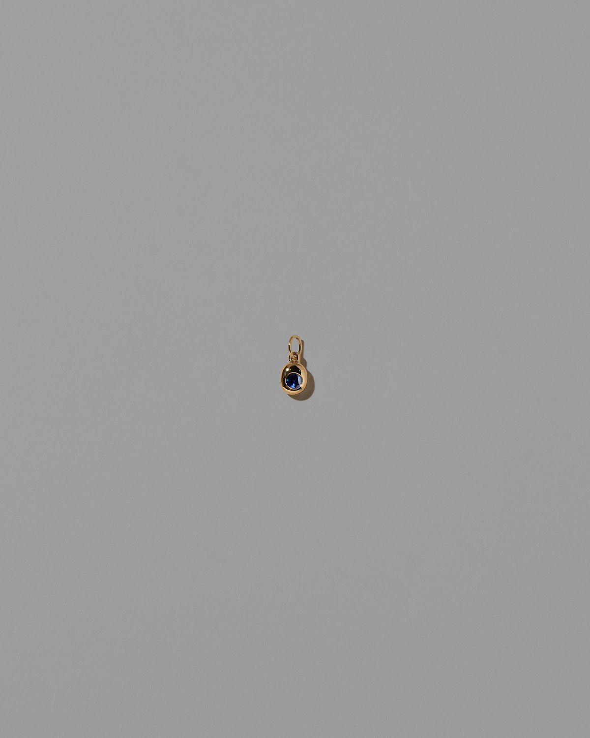 Sapphire Birthstone Level Charm on light color background.