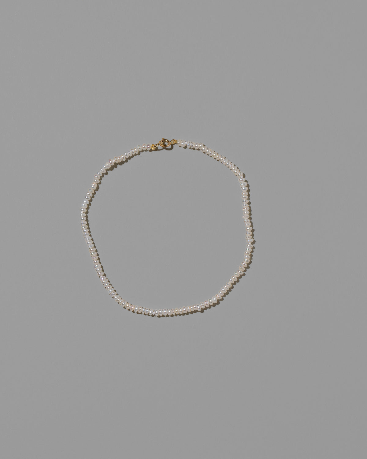 White Pebble Seed Pearl Anklet on light color background.