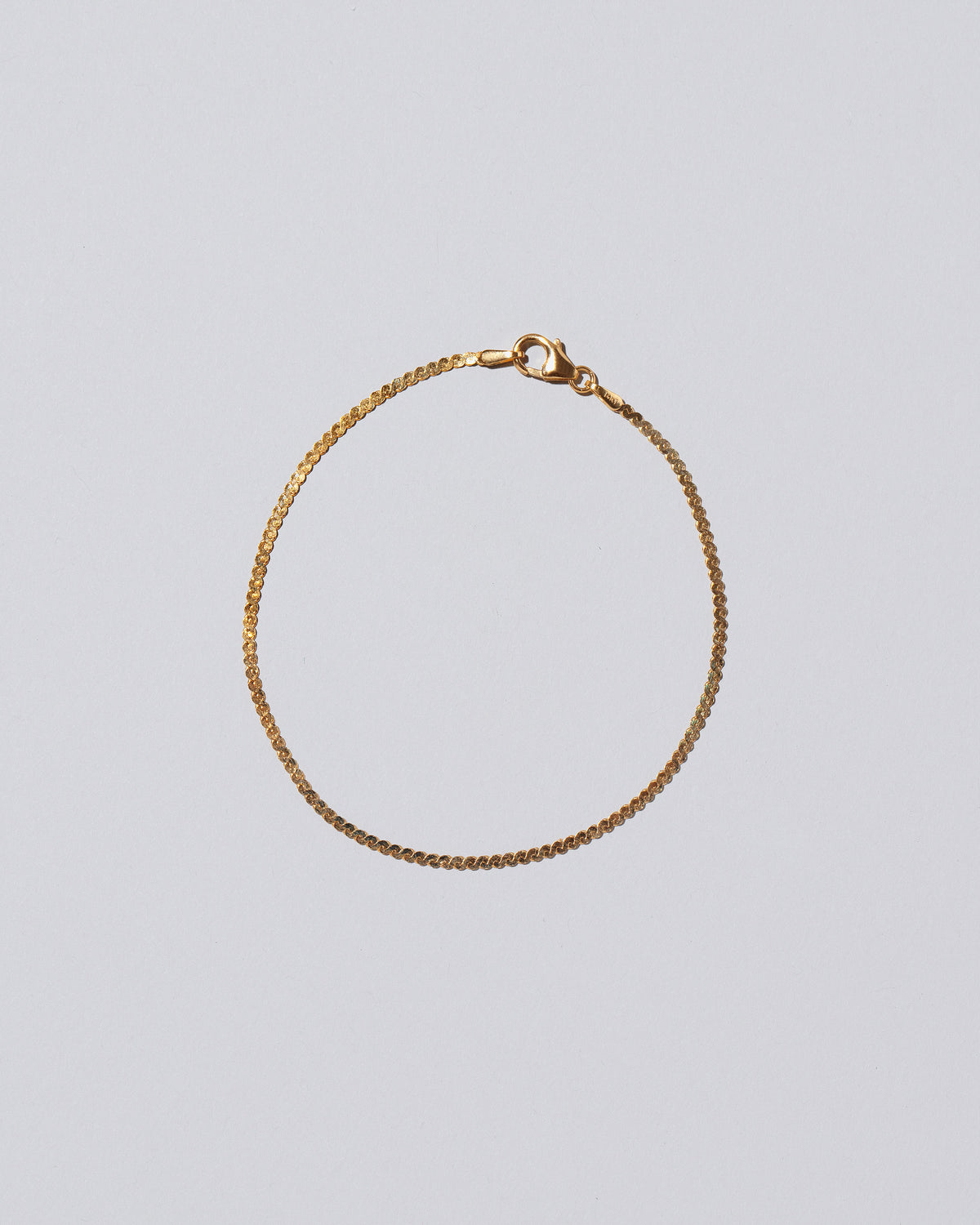 Yellow Gold Serpentina Chain Bracelet on light color background.