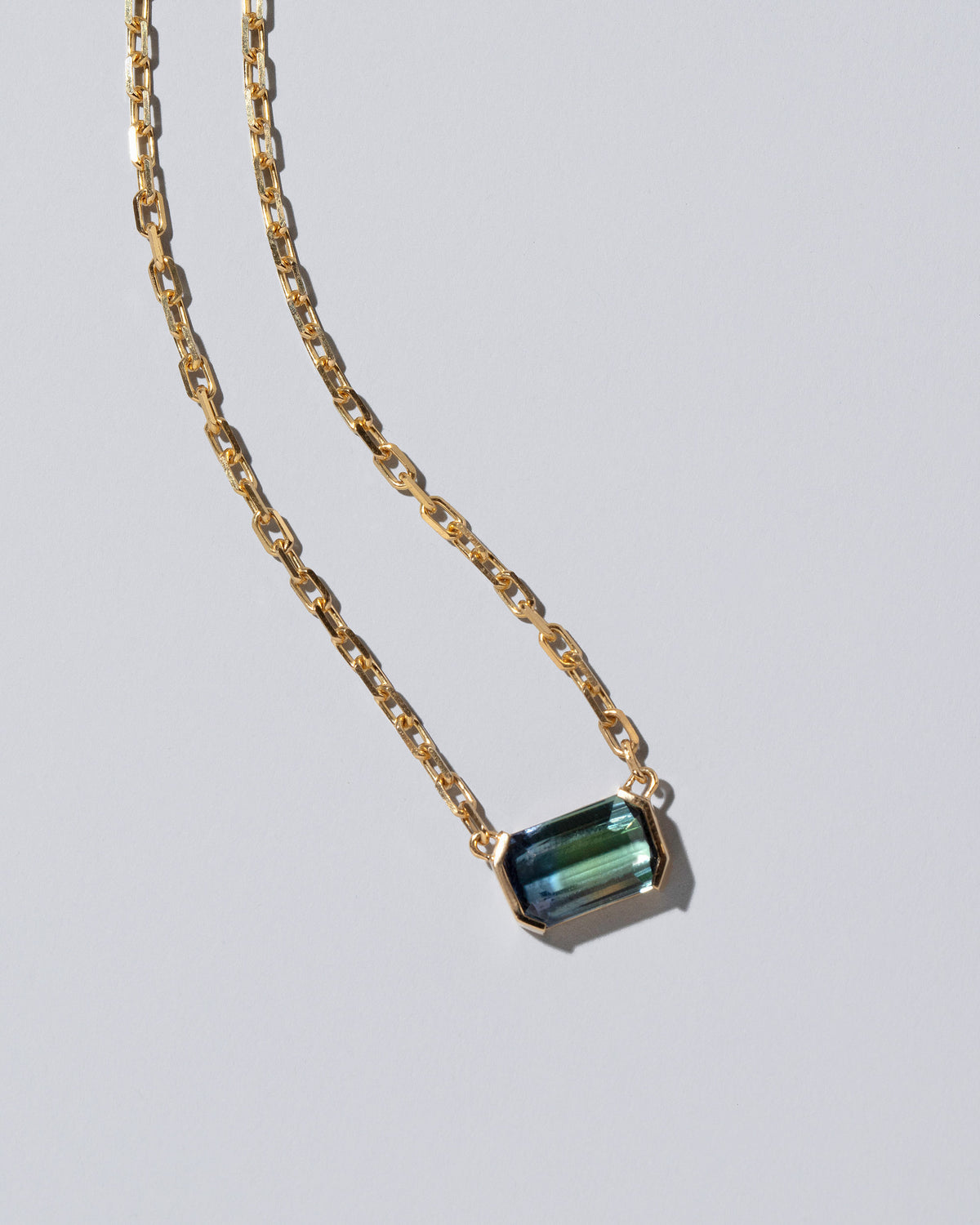 Closeup details of the Attunement Necklace on light color background.