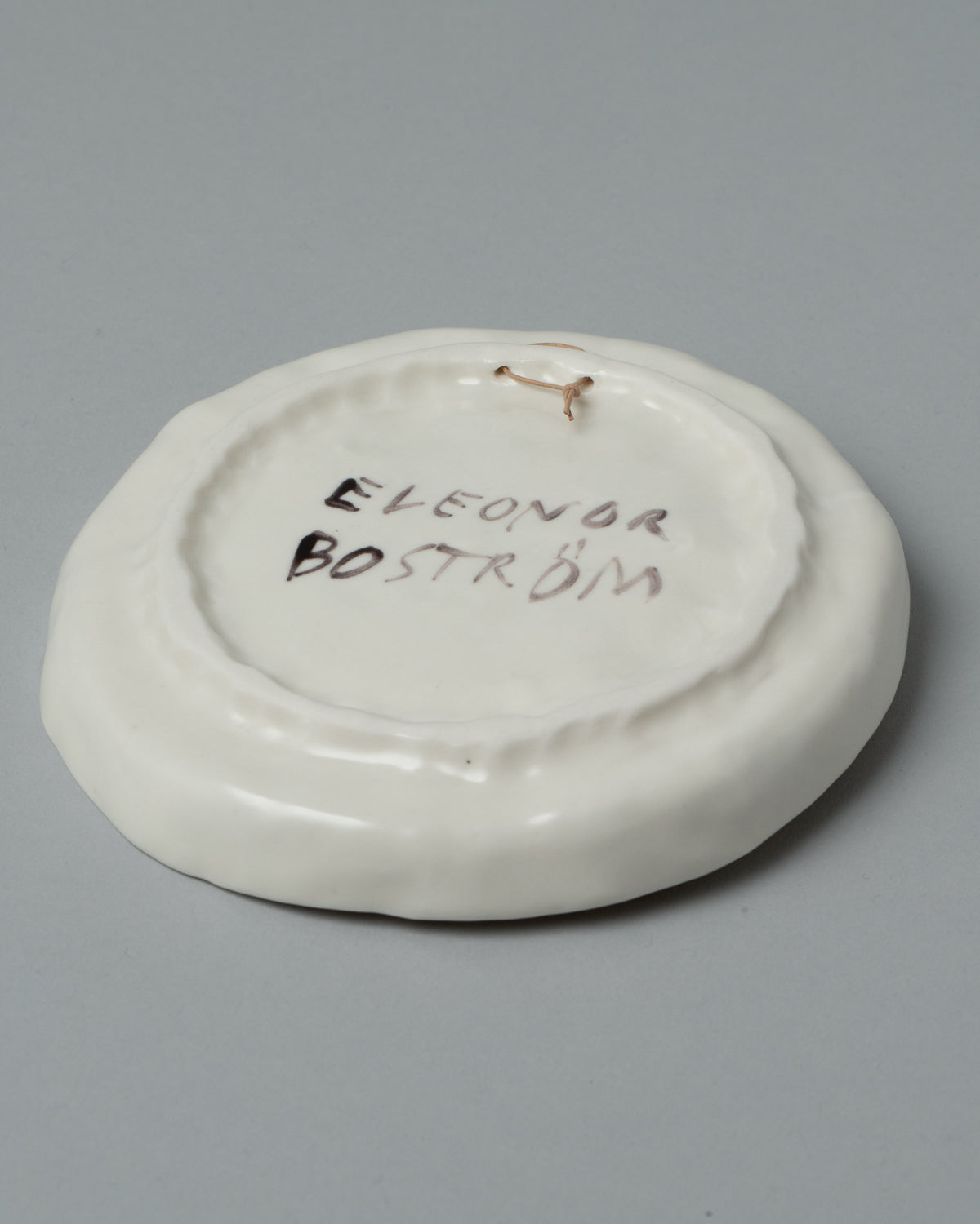 View from the back of the Eleonor Boström Hanging Dog Dish on light color background.