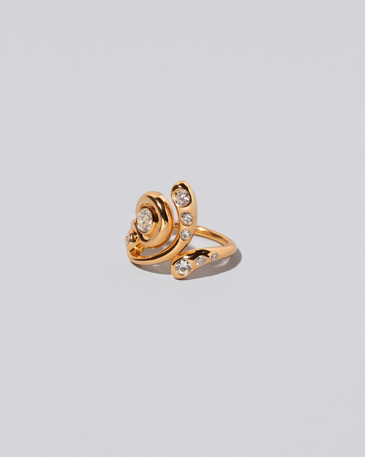 View from the side of the Twist It Ring on light color background.