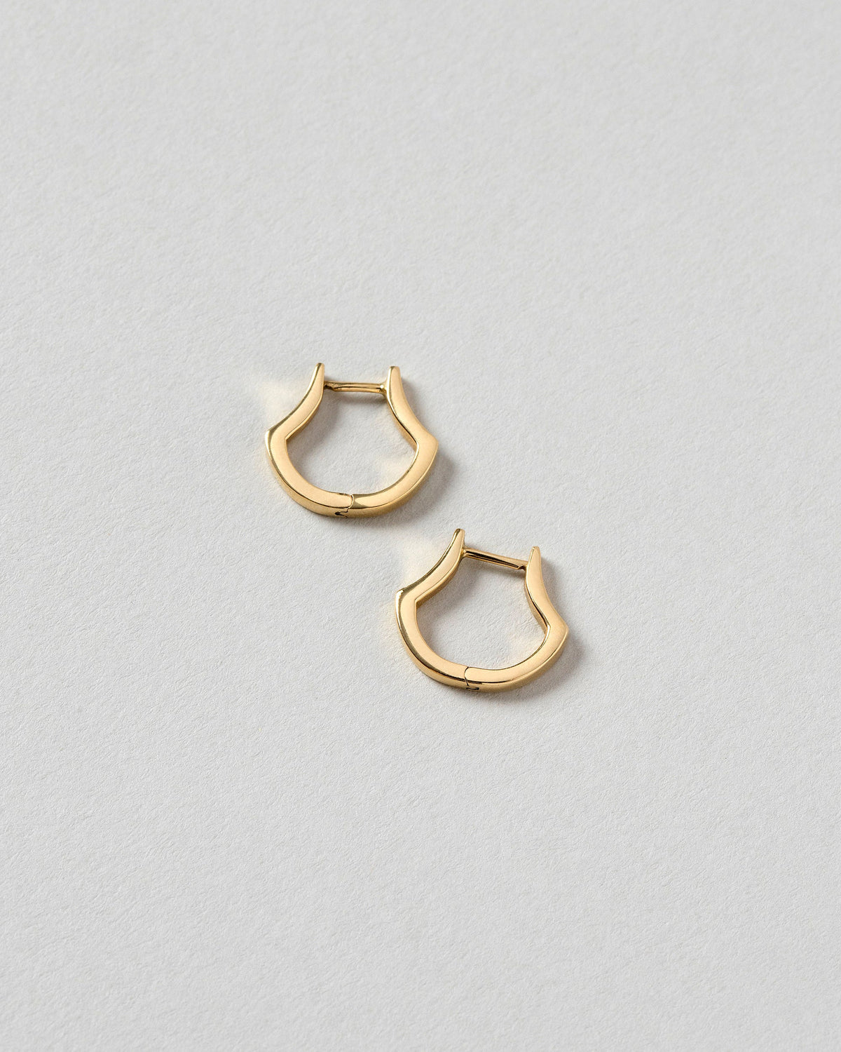 Madrone Flower Bud Hoop Earrings on light color background.